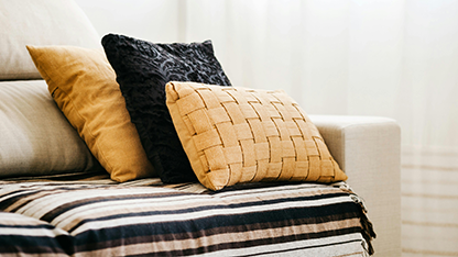 Decorative pillows placed on a white upholstered sofa